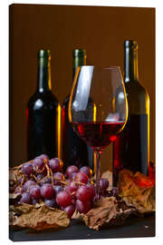 Leinwandbild  Rotwein mit Trauben und Weinblättern